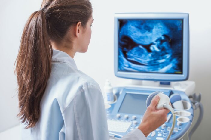 young woman doctor is viewing an ultrasound result to test for v